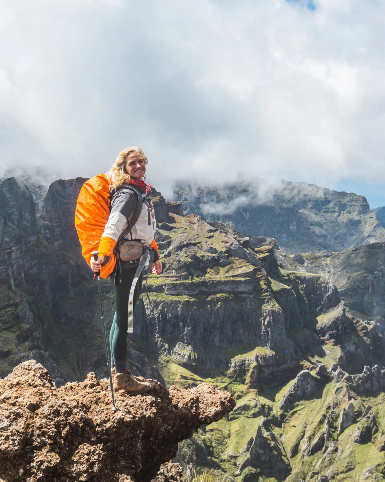hiker with orange backpack on a mountain ridge in Madeira